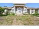 Charming single-Gathering home with front yard, columns, arched windows, and a decorative glass front door at 284 Peninsula Ave, Tarpon Springs, FL 34689