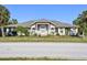 Charming single-story home with a manicured front yard and lush palm trees at 284 Peninsula Ave, Tarpon Springs, FL 34689