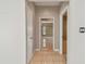 Hallway view showcasing access to living area and ample natural light at 284 Peninsula Ave, Tarpon Springs, FL 34689