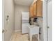 Bright laundry room featuring washer and dryer, utility sink, and wall-mounted cabinets at 284 Peninsula Ave, Tarpon Springs, FL 34689