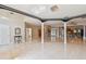 Spacious living area boasts glossy tile floors, bright lighting, and open floor plan at 284 Peninsula Ave, Tarpon Springs, FL 34689