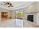 Comfortable living room with fireplace, deck access, and open to kitchen at 284 Peninsula Ave, Tarpon Springs, FL 34689