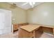 Neutral office space with a large wooden desk, storage cabinet, tiled floors and ceiling fan at 284 Peninsula Ave, Tarpon Springs, FL 34689