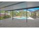 Outdoor pool area featuring tiled flooring, screened enclosure, outdoor seating, grill and more at 284 Peninsula Ave, Tarpon Springs, FL 34689