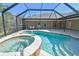 Inviting screened-in pool and spa area with an outdoor dining set offers a perfect spot for relaxation and entertainment at 284 Peninsula Ave, Tarpon Springs, FL 34689