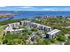Aerial view of condo complex with trees, landscaping, and beautiful water views at 2900 Cove Cay Dr # 1B, Clearwater, FL 33760