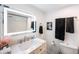 Modern bathroom with a bright, backlit mirror and vanity with black towels at 2900 Cove Cay Dr # 1B, Clearwater, FL 33760