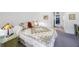Comfortable bedroom with a patterned quilt, bedside lamps, and a view of the adjoining hallway at 2900 Cove Cay Dr # 1B, Clearwater, FL 33760