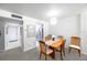 Charming dining area featuring a wooden table with seating for four, adjacent to a galley kitchen at 2900 Cove Cay Dr # 1B, Clearwater, FL 33760
