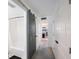 Hallway featuring a gray barn door leading to a bathroom with a shower-tub combo at 2900 Cove Cay Dr # 1B, Clearwater, FL 33760