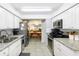 Modern kitchen with stainless steel appliances, granite countertops, and a view into the dining area at 2900 Cove Cay Dr # 1B, Clearwater, FL 33760