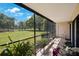 Relax on this screened lanai with views of the lush green lawn and garden at 2900 Cove Cay Dr # 1B, Clearwater, FL 33760