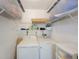 Laundry room with a washer, dryer, and wire shelving for organized storage at 2900 Cove Cay Dr # 1B, Clearwater, FL 33760