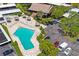 Aerial view of the community pool and lounge area with seating and parking at 2900 Cove Cay Dr # 1B, Clearwater, FL 33760