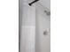 Clean, white tiled shower with a showerhead and curtain, ensuring a pristine bathing experience at 2900 Cove Cay Dr # 1B, Clearwater, FL 33760