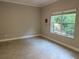 Bright bedroom featuring tile flooring and a large window offering natural light at 29823 Ganga Way, Wesley Chapel, FL 33543