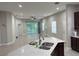 Open-concept kitchen featuring a granite island, stainless steel appliances, and ample natural light at 29823 Ganga Way, Wesley Chapel, FL 33543