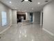 Open-concept living space with gray tile floors and modern kitchen at 29823 Ganga Way, Wesley Chapel, FL 33543