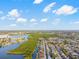 An aerial view of a canal neighborhood with blue skies and lush green trees nearby at 3139 Elkridge Dr, Holiday, FL 34691