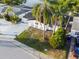 An elevated shot shows the home's curb appeal, front lawn, and palm trees at 3139 Elkridge Dr, Holiday, FL 34691