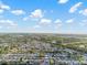 Expansive aerial view of a waterfront neighborhood with a blue sky and scattered white clouds at 3139 Elkridge Dr, Holiday, FL 34691