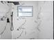 New shower features black fixtures and floor to ceiling tile with dark veining at 3139 Elkridge Dr, Holiday, FL 34691