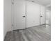 Spacious bedroom features modern gray wood-look flooring and fresh neutral paint at 3139 Elkridge Dr, Holiday, FL 34691