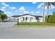 Charming single-story home featuring a freshly painted white exterior, well-manicured lawn, and lush landscaping at 3139 Elkridge Dr, Holiday, FL 34691