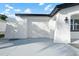 Attached two-car garage featuring a newly painted door and concrete driveway at 3139 Elkridge Dr, Holiday, FL 34691