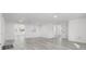 Expansive living room showcasing the open layout, light gray laminate floors, and fresh white paint at 3139 Elkridge Dr, Holiday, FL 34691