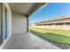 Back patio with view of backyard lawn with perimeter fence at 33105 Major Oak Dr, Wesley Chapel, FL 33545