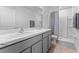 Bathroom with double sink vanity and a shower with curtain at 33105 Major Oak Dr, Wesley Chapel, FL 33545