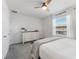 Bedroom with white walls, ceiling fan, and large window with blinds at 33105 Major Oak Dr, Wesley Chapel, FL 33545