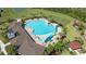 Aerial view of community pool featuring spacious deck, shade structures, and lounge chairs at 33105 Major Oak Dr, Wesley Chapel, FL 33545