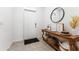 Bright entryway featuring a console table with décor and a round mirror at 33105 Major Oak Dr, Wesley Chapel, FL 33545