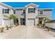 Inviting townhome featuring a clean gray exterior, one-car garage and tidy landscaping at 33105 Major Oak Dr, Wesley Chapel, FL 33545
