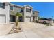Charming townhome featuring a one-car garage and small landscaping with a long driveway at 33105 Major Oak Dr, Wesley Chapel, FL 33545