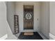 Stylish front door with a decorative wreath and welcome sign, offering a warm entrance at 33105 Major Oak Dr, Wesley Chapel, FL 33545