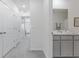 Hallway with gray carpet leading to bedrooms and a bathroom at 33105 Major Oak Dr, Wesley Chapel, FL 33545