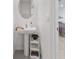 Well-lit powder room featuring a modern pedestal sink and a decorative shelf at 33105 Major Oak Dr, Wesley Chapel, FL 33545