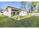 Spacious backyard with a covered patio, lush lawn, and privacy fence, ideal for outdoor activities at 3326 W Heiter St, Tampa, FL 33607