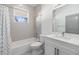 Bright bathroom features subway tile, shower-tub combo, and white vanity at 3326 W Heiter St, Tampa, FL 33607