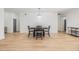 Well-lit dining room features modern chandelier, laminate flooring, and neutral paint at 3326 W Heiter St, Tampa, FL 33607