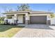 Charming single Gathering home featuring a two car garage, stone accents, and a covered front porch at 3326 W Heiter St, Tampa, FL 33607