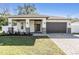 Beautiful single Gathering home featuring a two car garage, stone accents, and a covered front porch at 3326 W Heiter St, Tampa, FL 33607