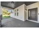 Covered front porch featuring a dark gray front door, black exterior lighting, and stone accents at 3326 W Heiter St, Tampa, FL 33607