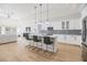 Bright kitchen features an island with bar seating, stainless appliances, and flows into a living space at 3326 W Heiter St, Tampa, FL 33607