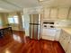 Well-equipped kitchen featuring a stainless steel refrigerator and a classic white range at 34461 Cactus Dr, Pinellas Park, FL 33781