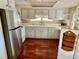 Kitchen boasts stainless steel appliances and clean white cabinetry with ample counter space at 34461 Cactus Dr, Pinellas Park, FL 33781