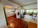 Open layout showcasing the kitchen and living room with hardwood and wood-style flooring at 34461 Cactus Dr, Pinellas Park, FL 33781